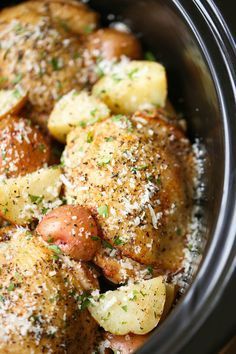 a close up of food in a crock pot with seasoning sprinkled on top