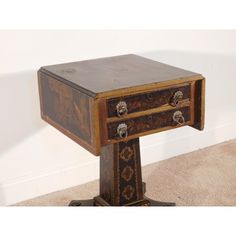 an old wooden table with two drawers on it