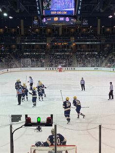 an ice hockey game in progress with the goalie getting ready to catch the puck