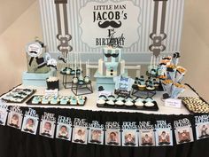 a table topped with cupcakes and cakes next to a sign that says little man's birthday