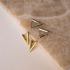 Add a bit of modern edge to your outfit with our Triangle Huggies. These unique geometric earrings show off your summer style and make for a perfect complement for a bikini and an oversized linen shirt cover-up! Material: High Quality Solid 925 Sterling Silver Finish: Sterling Silver ∙ 18K Gold Featuring 15mm Triangle Huggie Hoops, 2mm thickness SKU: RR-ER159 Modern Hoop Earrings, Oversized Linen Shirt, Earrings Triangle, Earrings Minimalist, Huggie Earrings, Modern Earrings, Geometric Earrings, Minimalist Earrings, Huggies Earrings