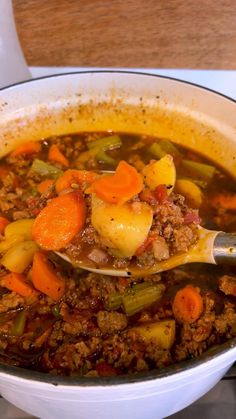 a white bowl filled with meat and vegetables