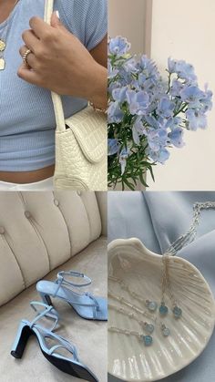 a woman holding a white purse next to blue flowers and other items on a table