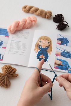 someone is crocheting together with yarn and knitting needles to make a doll book