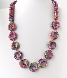 I love these unique Mother of Pearl in Resin beads! Primarily pink, the many other colors within the beads mean that this statement necklace is one you can wear again and again! The MOP beads are very difficult to find so when I saw them at a Gem Show I had to have them! There is such a rich translucent appearance that is deep and rich.The 22 inch length is perfect with a sundress or a tunic top and capris. I used rondelle shapes and then added the one inch circular shape beads separated by 4mm Crystal Statement Necklace, Bold Necklace, Silver Chain Style, Handmade Gifts For Her, Long Beaded Necklace, Pink Necklace, Colorful Jewelry, Swarovski Crystal Earrings, Resin Beads