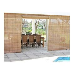 an outdoor dining area with sliding doors that open up to the patio and pool in the background