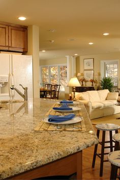 a large kitchen with an island in the middle and lots of counter space on each side