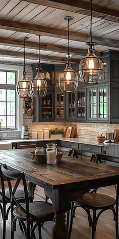 a kitchen filled with lots of wooden furniture and lights hanging from the ceiling next to a dining room table