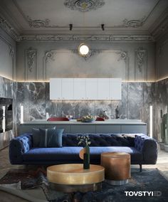 an elegant living room with blue couches and gold accents on the walls, along with marble flooring