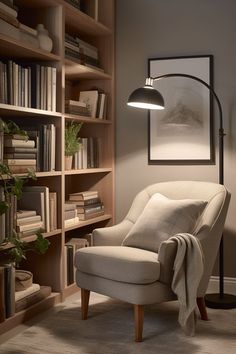 a living room with a chair, bookshelf and lamp