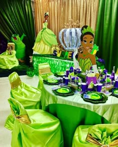 the table is set up for a princess and the frog birthday party with green decorations