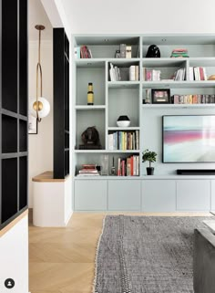 a living room filled with lots of furniture and bookshelves on top of each other