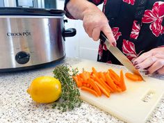 a woman is cutting carrots on a cutting board