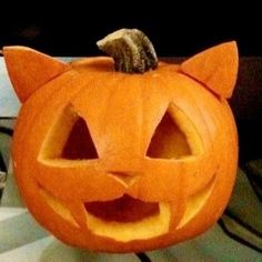 a pumpkin that has been carved to look like a cat