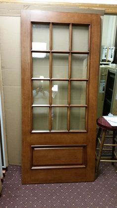 a large wooden door with glass panels in a room