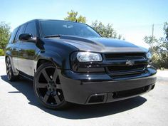 the front end of a black chevrolet suv