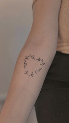 a woman's arm with a tattoo that says love and two birds on it