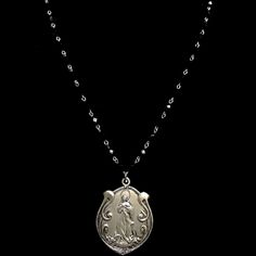 Grace and beauty abound in this simple, yet powerful our Art Nouveau Madonna medallion that has been hand cast from the vintage original dating from approximately 1906. She hangs from 36" of Black Jet beads and is long enough to wear double wrapped. A decorative toggle provides a beautiful effect. The image of the Assumption of the Blessed Virgin was hand carved based upon the painting by Spanish artist Bartolome Esteban Murillo (1618 - 1682). The image is captivating and Her face on the medalli Black Spiritual Jewelry With Antique Finish, Memorial Medallion Necklace With Antique Finish, Black Medallion Necklace With Vintage Charm, Black Oxidized Medallion Jewelry, Black Medallion Locket Necklace, Garnet Necklace Gold, Trinity Necklace, St Christopher Medal, Angel Bracelet