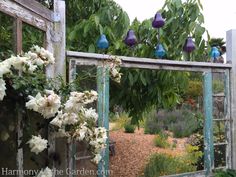 an old window frame with flowers on it and some blue birds sitting on top of the mirror