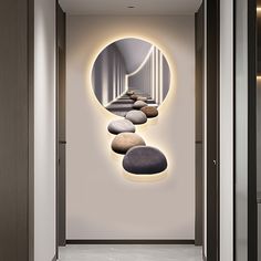 a long hallway with rocks in the middle and a circular mirror on the wall above it