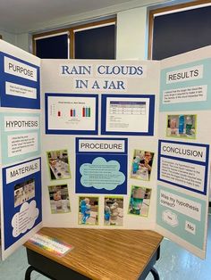 a table with a poster on it and other information about rain clouds in a jar