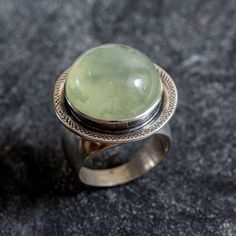 Prehnite Ring set with a Natural Prehnite in a top quality, natural inclusion & green shine, sourced from South Africa - this stunning stone is quite rare in this size of 18mm diameter, weighting 20 Carats.  Vintage Ring design made of Solid 925 Sterling Silver ☞ made to last. Matching Pendant: www.etsy.com/listing/1073071305 Matching Earrings - please ask me May Birthstone - Genuine & Natural Stones ❀ ☞ Choose your size ☞ I resize (before shipping) for FREE to Any size* ⌛Last Ring left ⌛ ❀ Each Green Ring, Cute Gift Boxes, Real Jewelry, May Birthstone, Design Silver, Vintage Ring, Boutique Jewelry, Ring Vintage, High Quality Jewelry