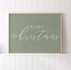 a merry christmas sign hanging on the wall