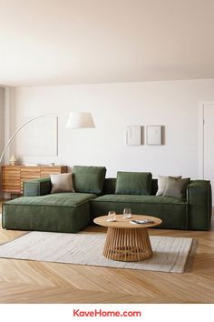 a living room with a green couch and coffee table on the floor in front of a white wall