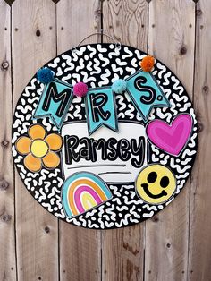 a sign that says mrs ramsay on the side of a wooden fence with flowers and hearts