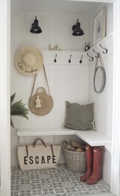 the entryway is clean and organized with baskets, hats, and booties on display