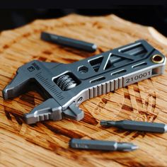 a knife that is laying on top of a cutting board with other tools around it