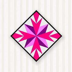 a pink and purple geometric design on a white wall