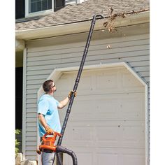 a man with a chainsaw in front of a house