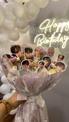 a person holding a bunch of balloons with pictures on it and the words happy birthday