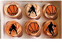 cupcakes decorated with basketball silhouettes are in a box