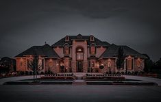 a large house lit up at night with lights on