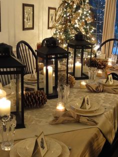 an image of a table setting with candles and place settings on it for christmas dinner