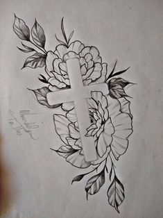 a drawing of a cross with flowers and leaves around it, on top of a piece of paper