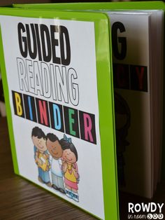 a book with the title guided reading binder written on it and two children hugging each other