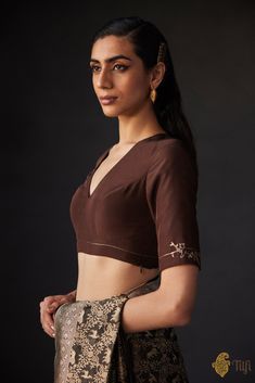 "A statement blouse with a minimal design featuring the silhouette of a leopard delicately hand-embroidered on the sleeves. It features a classic v-neck and adjustable criss-cross straps in the back for a distinctive saree accent.\u00a0\n\n\n\n Color - A shade of Brown\n\n Fabric - Pure silk\u00a0\nPlease allow 10-12 business days for despatch.\u00a0\n\n" Jungle Scene, Shade Of Brown, Statement Blouse, Brown Fabric, Embroidered Blouse, Cross Straps, Minimal Design, Pure Silk, Criss Cross