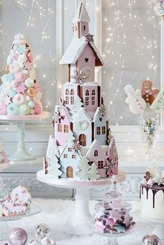 a table topped with cakes covered in frosting next to christmas trees and other decorations