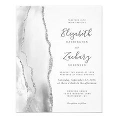 an elegant wedding card with silver foil on the front and back, featuring a white marble background