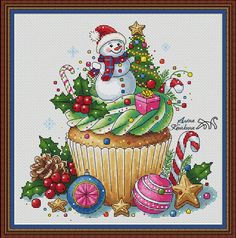 a cross stitch christmas card with a snowman sitting on top of a cupcake