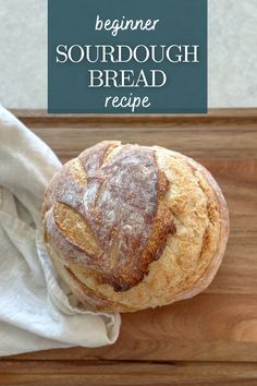 a loaf of sourdough bread sitting on top of a cutting board next to a napkin