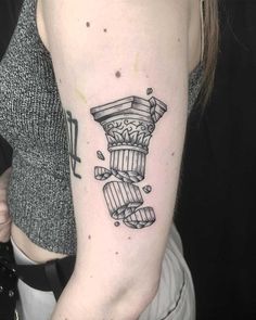 a woman's arm with a black and white tattoo design on her left arm