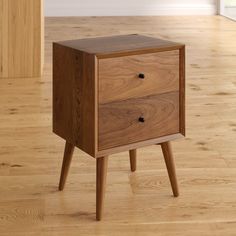 an end table with two drawers on one side and wooden legs, in the middle of a wood floor