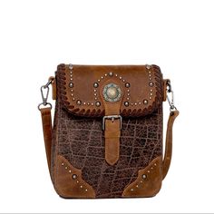 Made Of 100% Genuine Leather This Crossbody Has: Croc Embossed Patina Antique Gold Berry Concho Accented With Antique Silver Studs And Leather Whipstitch Flap With Magnetic Button Closure Top Zipper Closure Inside Of Clutch Include A Zippered Pocket And An Open Pocket A Zippered Pocket On The Back Detachable And Adjustable Shoulder/Crossbody Leather Strap 8.5" X 2" X 9.5" (Drop 24") Brown Crossbody Wallet, Leather Phone Bag With Snap Closure For Travel, Leather Crossbody Phone Bag With Snap Closure, Leather Phone Bag With Snap Closure Crossbody, Textured Leather Rectangular Saddle Bag, Rectangular Textured Leather Saddle Bag, Brown Textured Leather Crossbody Flap Bag, Flap Shoulder Bag With Snap Closure, Rectangular Leather Phone Bag With Snap Closure