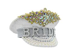 Sparkle, shine, and strut your fabulous self in this White And Gold Sequin Bride Captain Hat. Featuring beautiful white hat with gorgeous faux gems accented with gold trim and faux pearls in white, cream, and silver. Bride Banner accented with silver rhinestones. Hat stands about 7 inches tall, 11 inches long and is 10.5 inches wide. Fitting approximately 58 cm, each hat includes an elastic strap inside the opening for a more customized fit. Perfect for Weddings, Bachelorette Parties, Festivals Sequin Hat, Festival Costume, Gender Fluid, Bride Hat, Festival Costumes, Sparkle Wedding, Hat Stands, Bachelorette Parties, White Hat