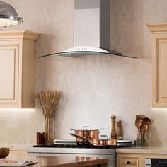 a stove top oven sitting inside of a kitchen next to wooden cabinets and counter tops