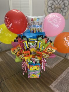 a birthday gift basket with balloons and candy